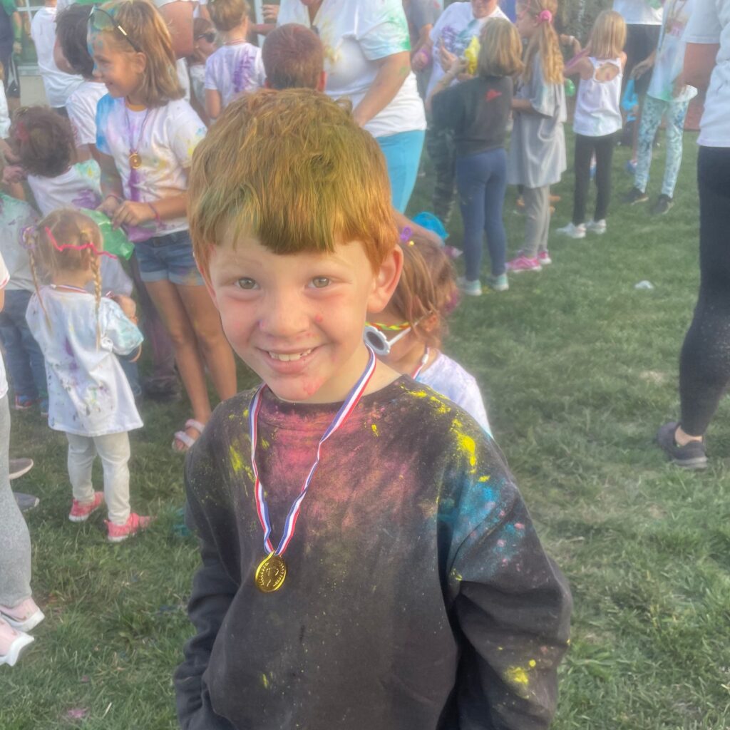 Boy covered in color dust